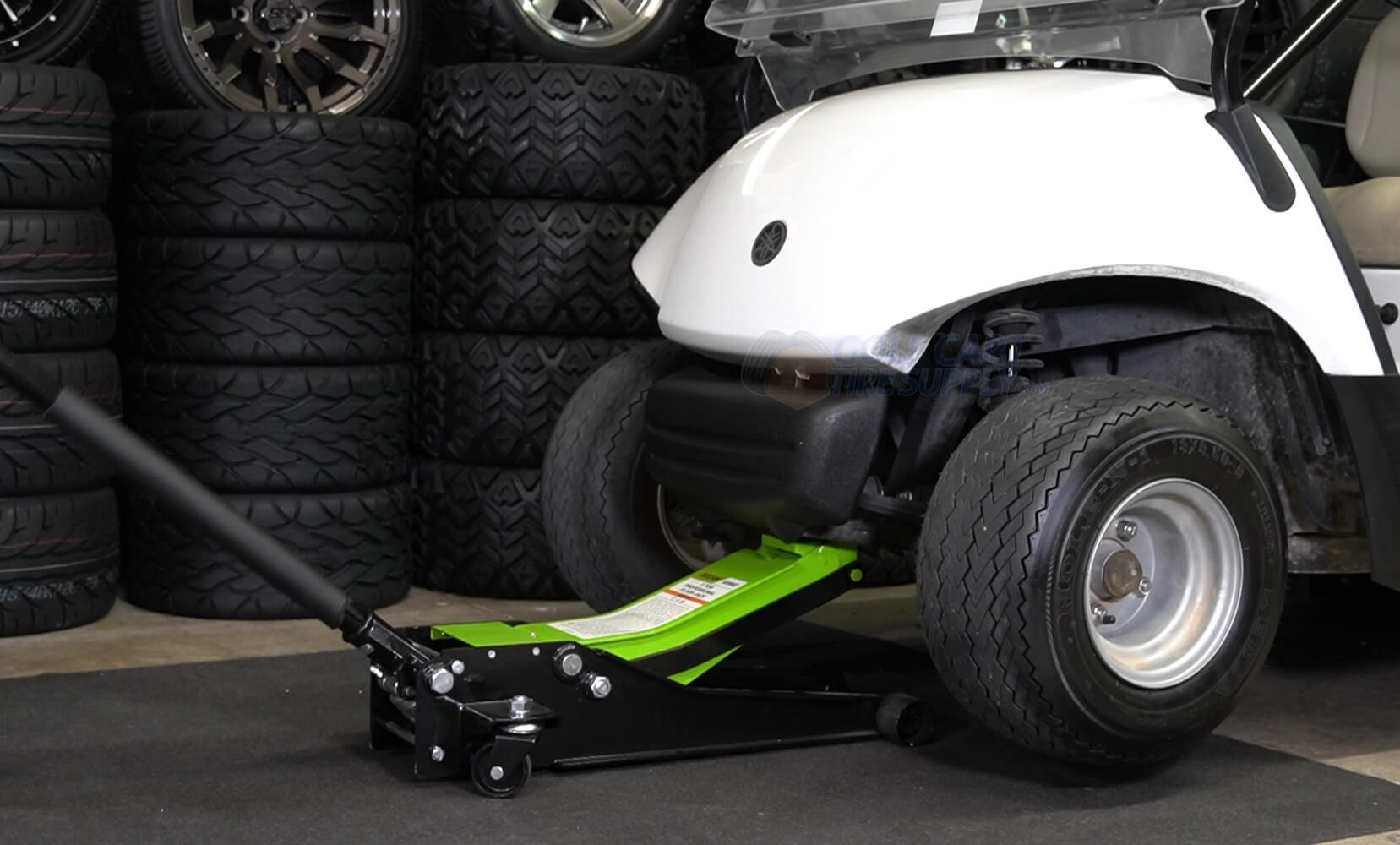 Golf Cart being jacked up using a floor jack